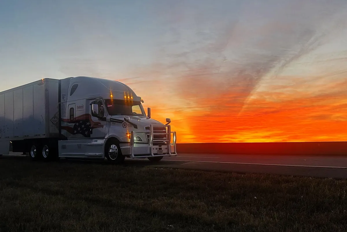 MSR truck at sunrise with the driver's dog looking out the window